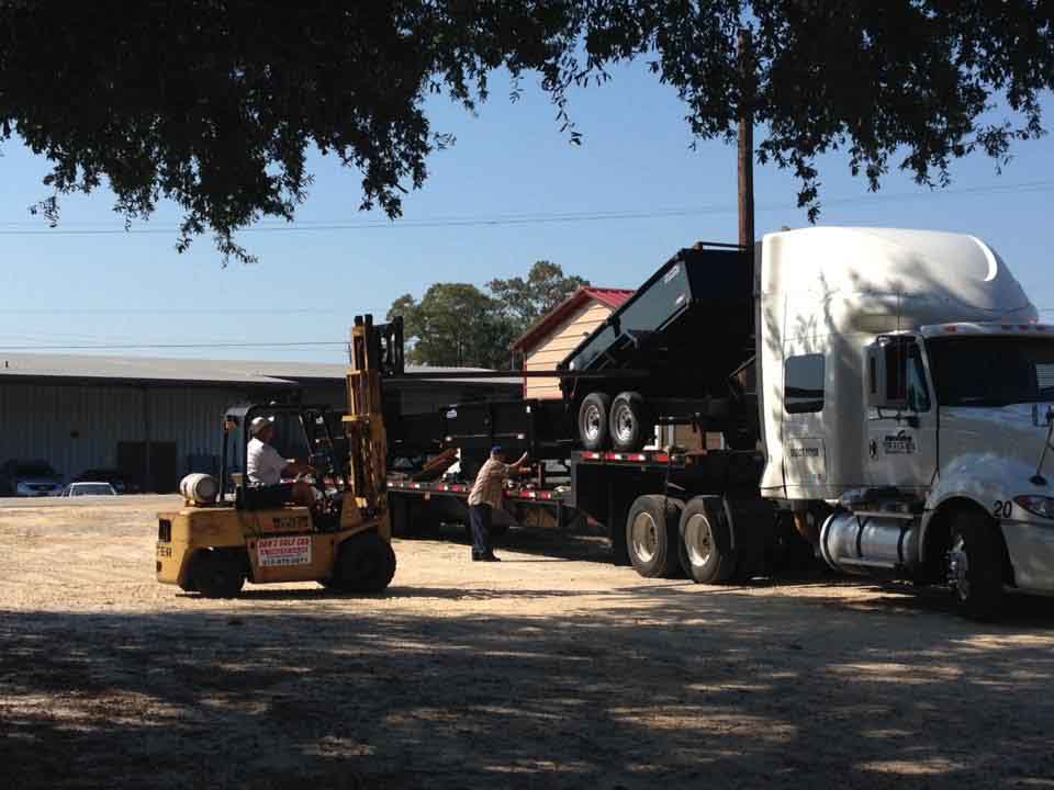 Semi Truck with Stack of Black Utility Trailers